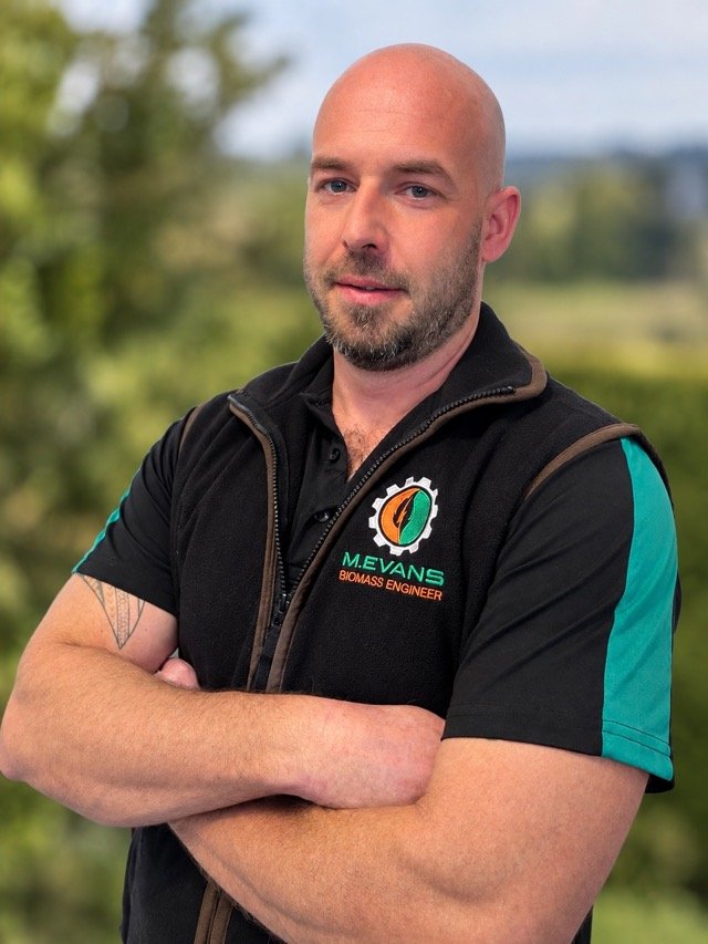 Mark Evans, arms folded, in branded M.Evans workwear.